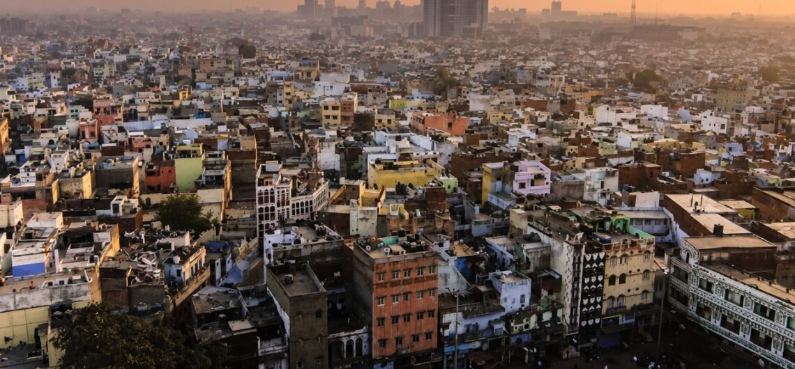 Split view of Old Delhi's Jama Masjid and New Delhi's India Gate showing historic and modern Delhi